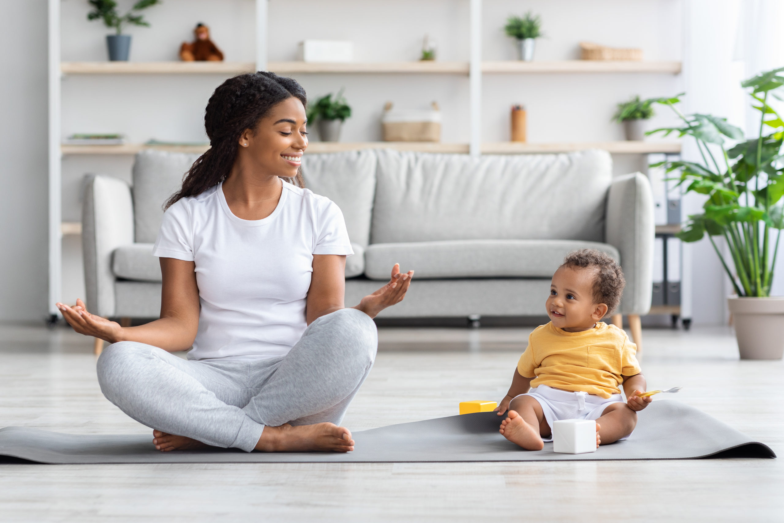 Trainings With Baby. Black Mother And Toddler Son Practicing Yoga At Home